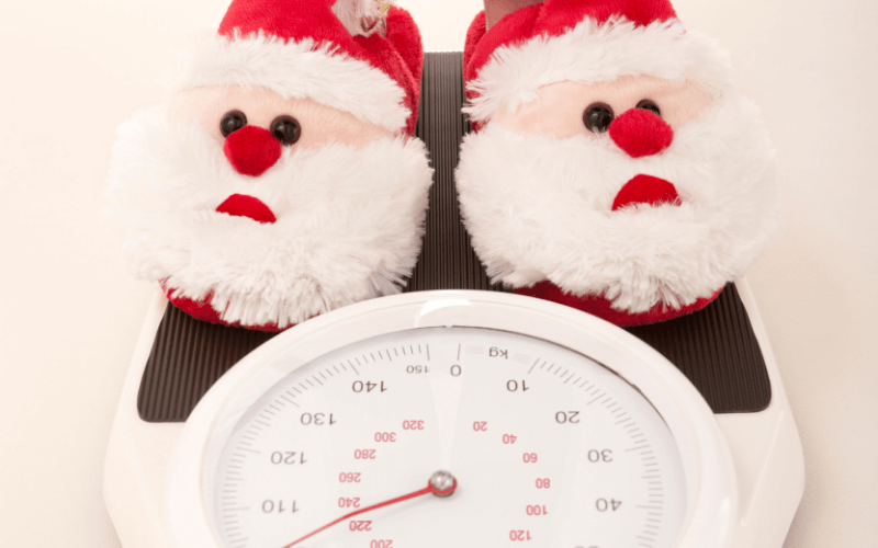 pair of santa slippers on a scale