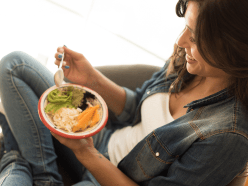 woman eating acai bowl