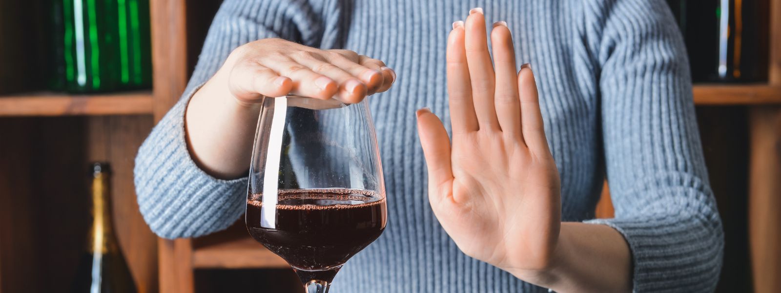 woman placing her hand over a glass