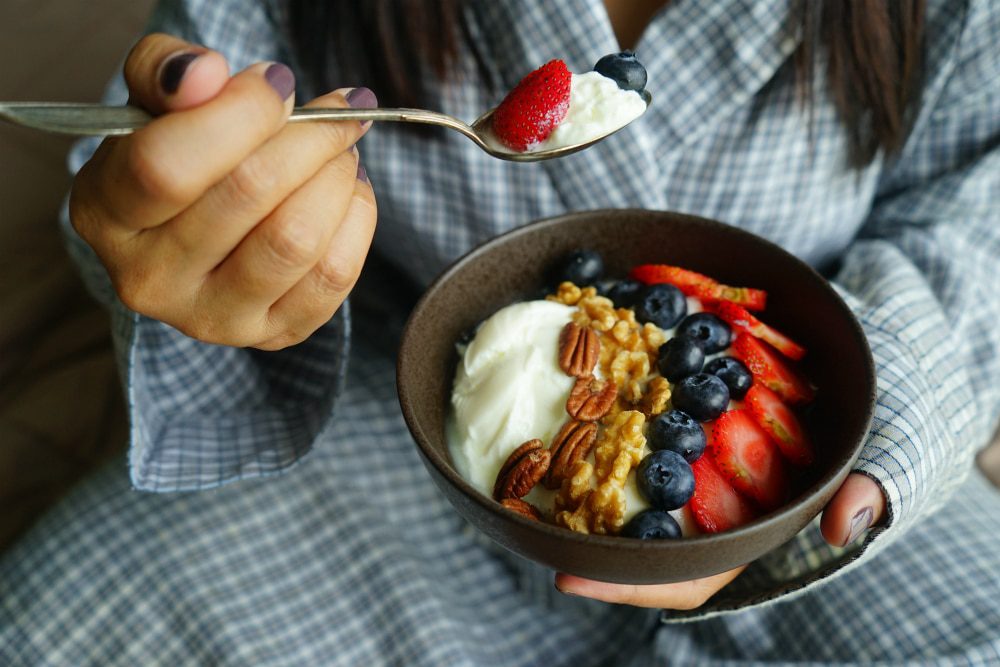 person eating a keto dessert bowl